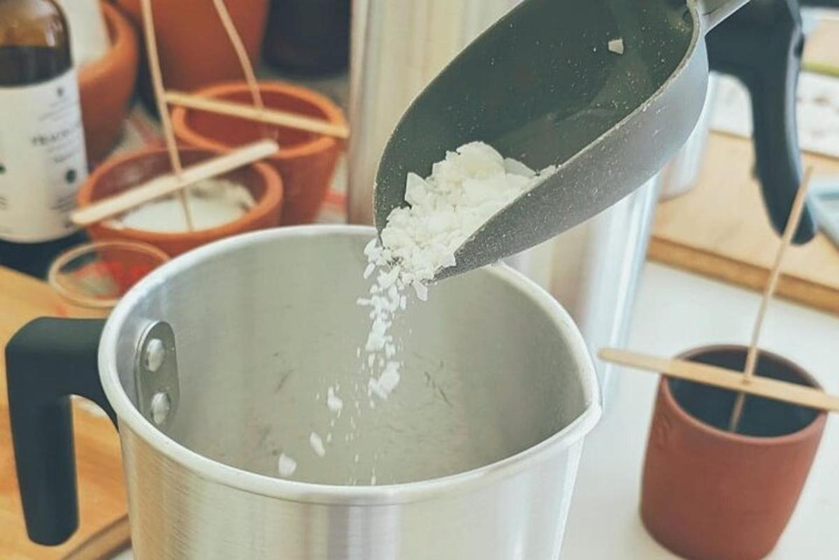 a person adding sugar into a measuring cup