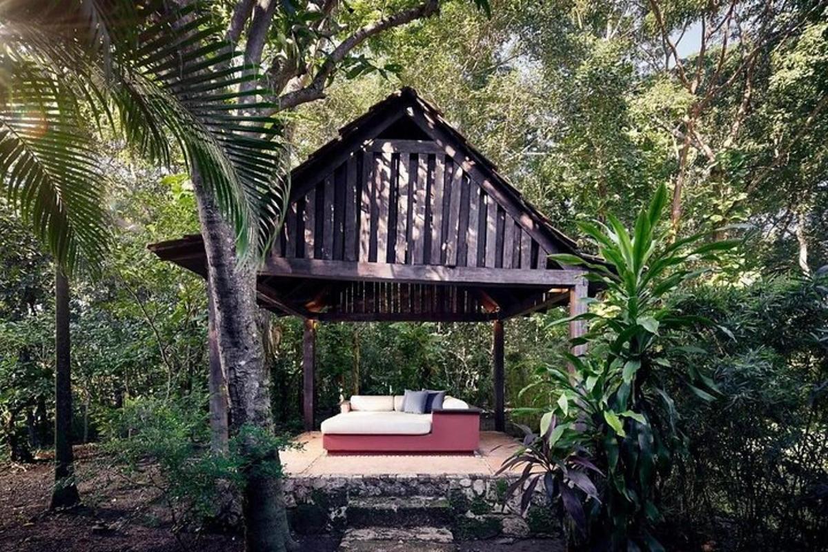 a tree house with a couch in the forest