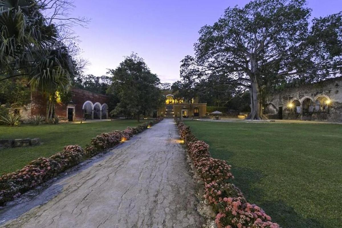 a cobblestone street in a park with flowers