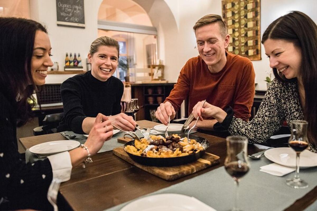 hópur fólks situr við borð og borðar mat