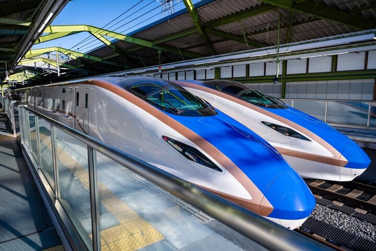 two high speed trains parked in a train station