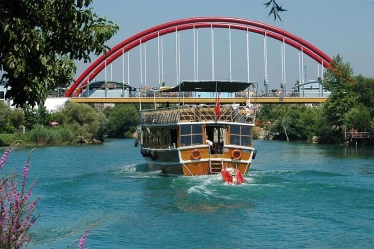 a boat in the water under a bridge