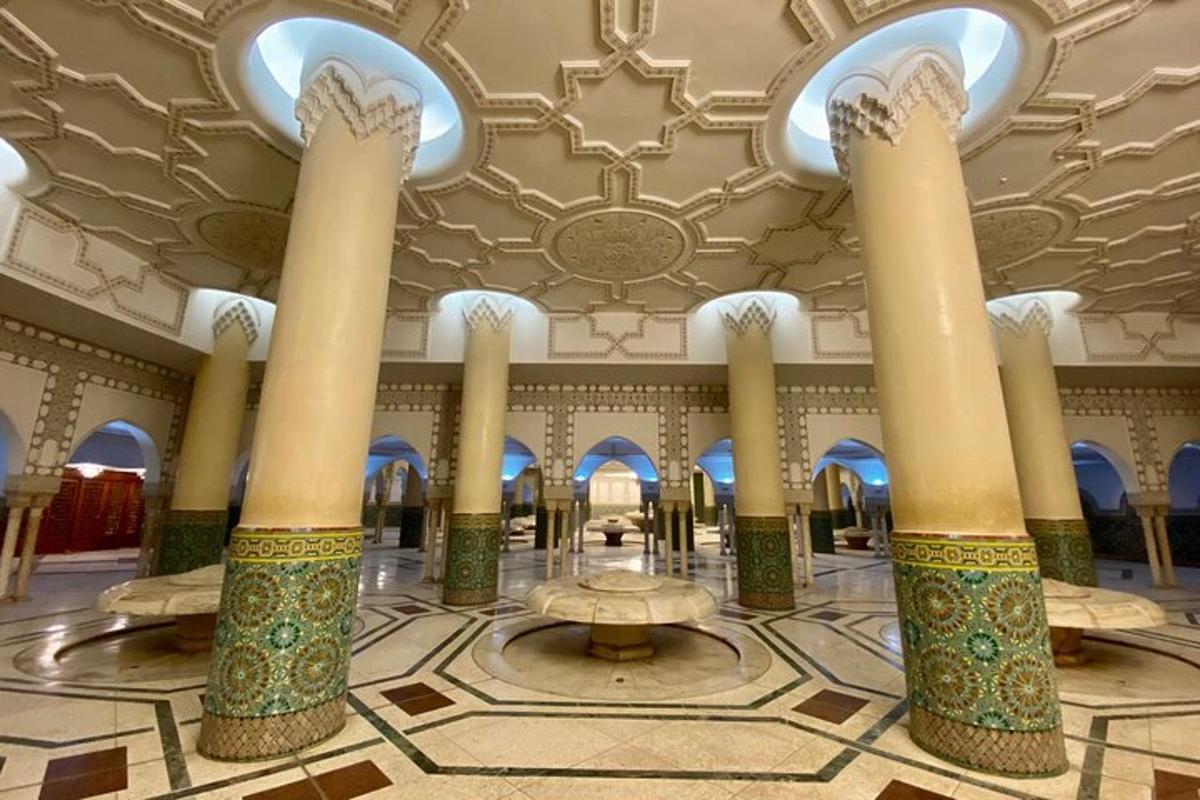 a lobby of a mosque with columns and ceilings
