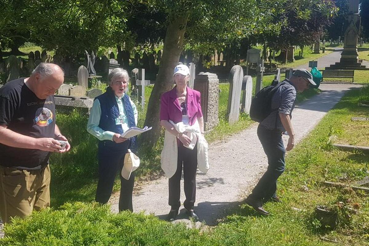 a group of people standing in a cemetery