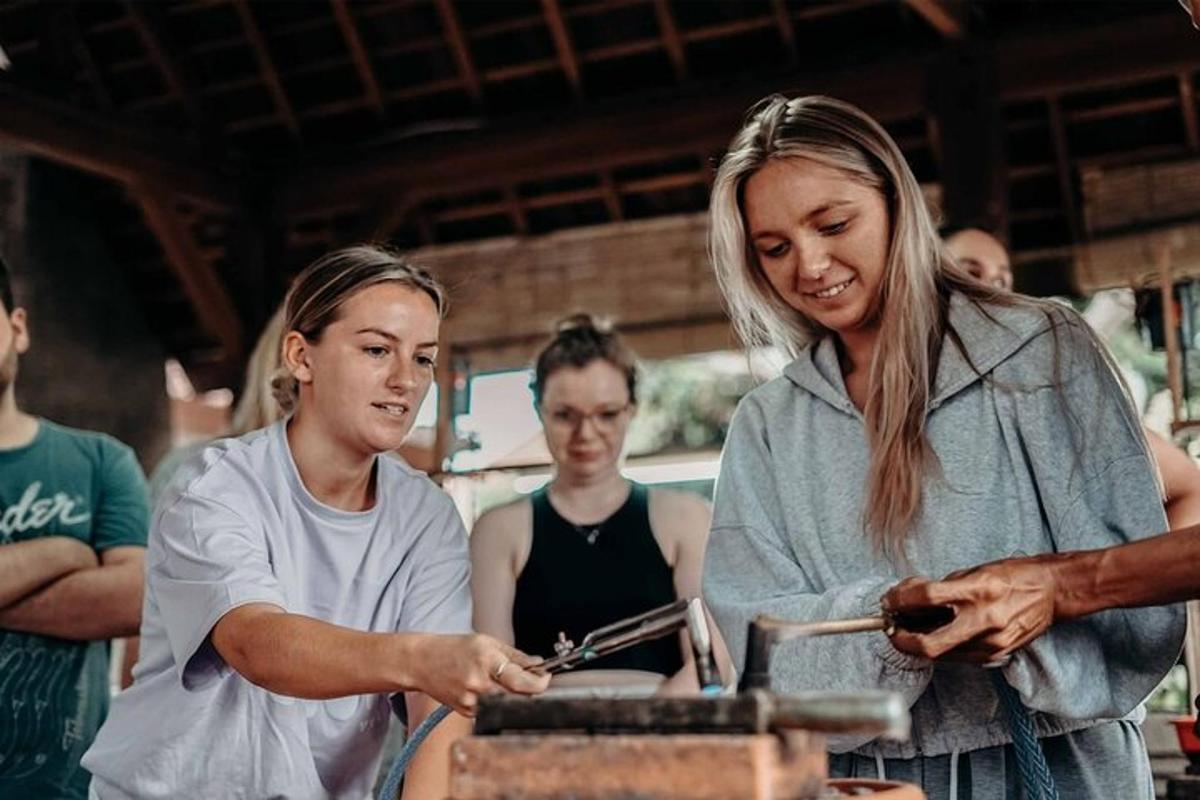 a woman standing next to a woman preparing food
