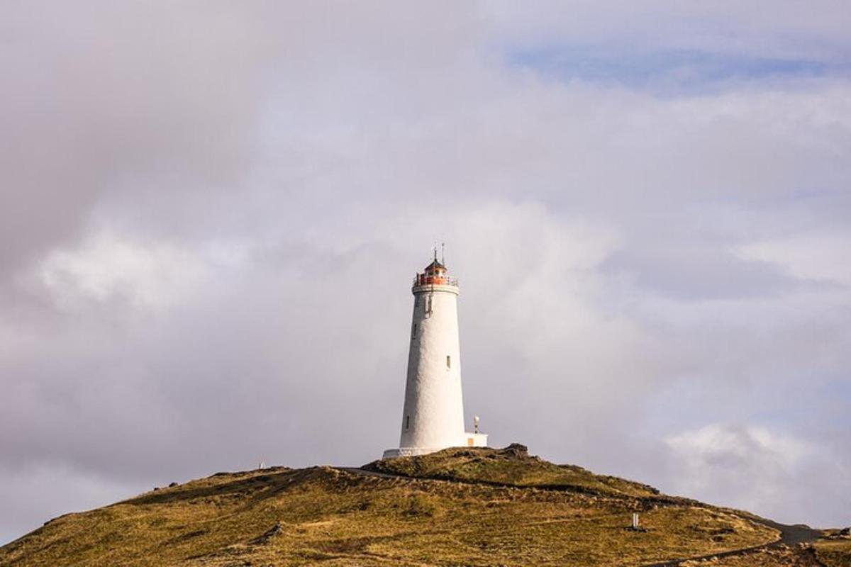 a lighthouse sitting on top of a hill