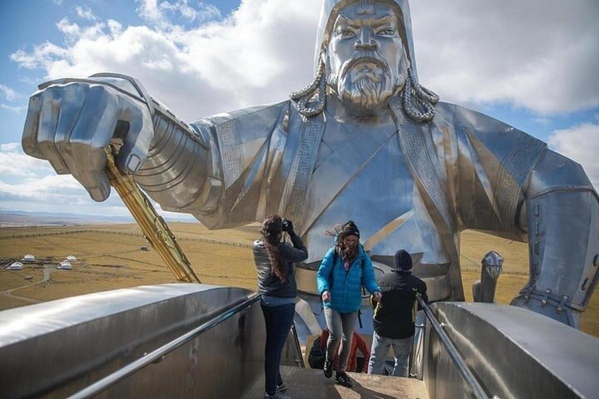a group of people standing in front of a large statue