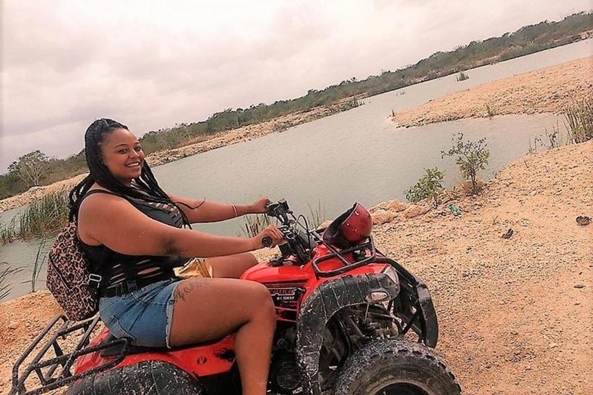 a woman sitting on a wheeler near a river