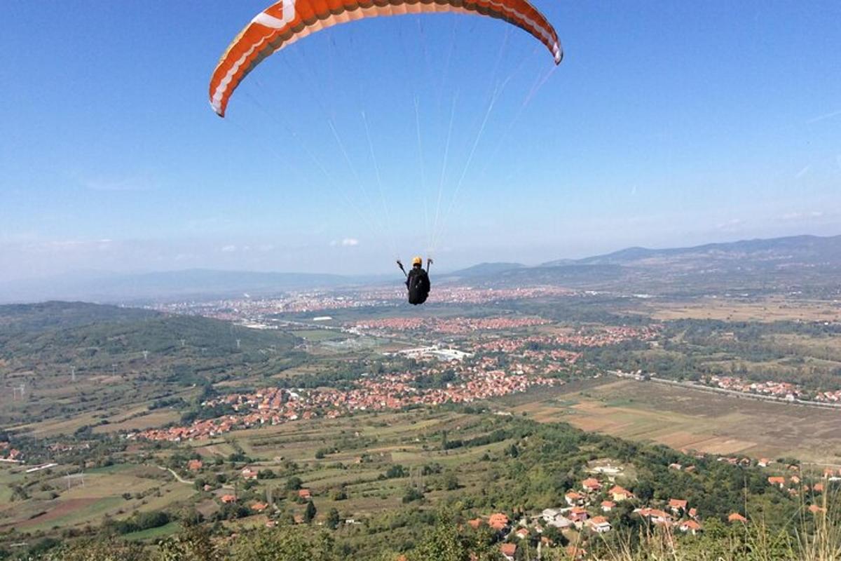 a person flying a parachute in the sky