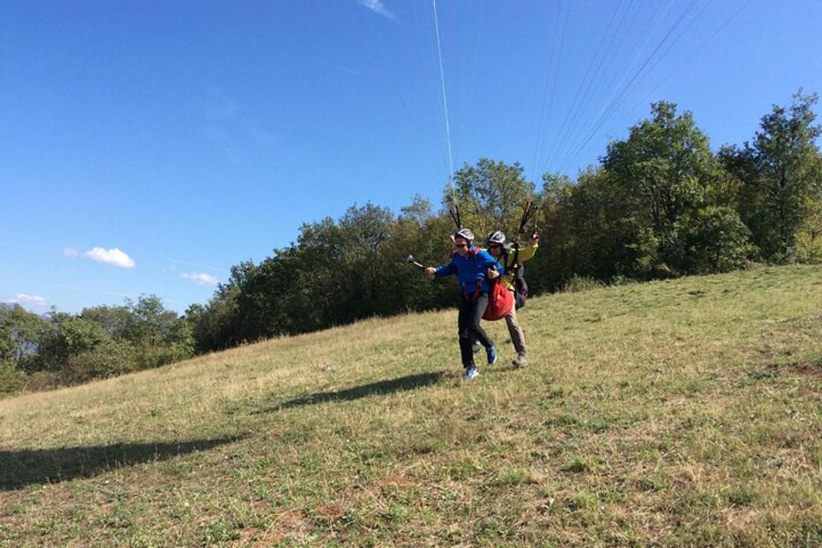 two people are flying a kite in a field