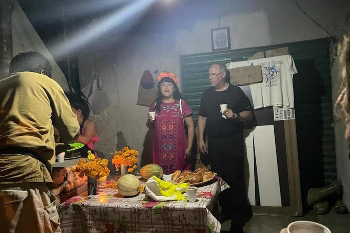 sekumpulan orang berdiri di sekeliling meja dengan makanan