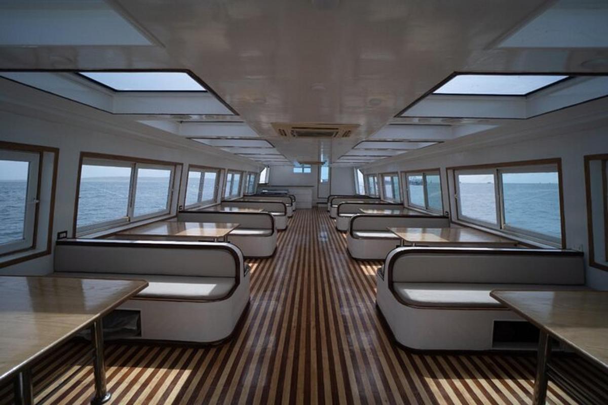 a train car with benches and tables and windows