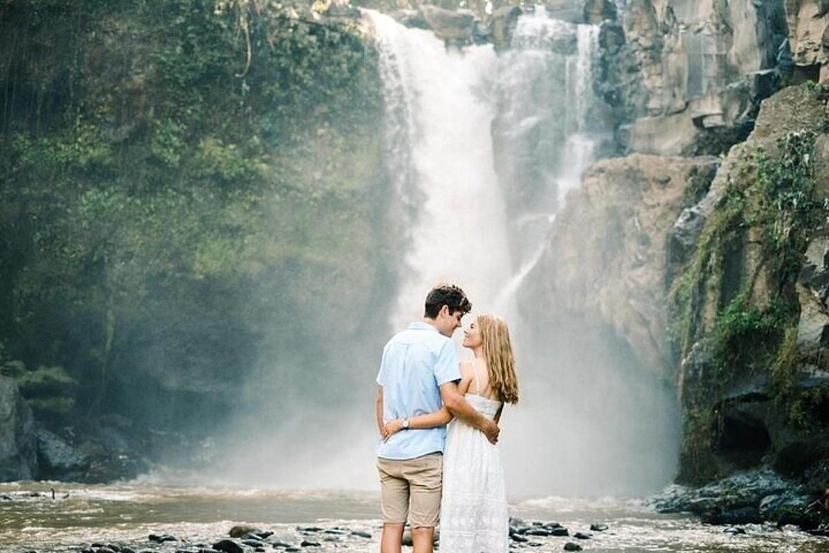 una sposa e uno sposo in piedi davanti a una cascata