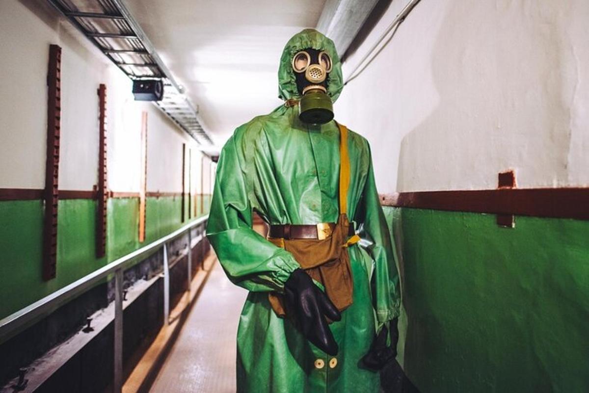 a person in a gas mask standing in a hallway