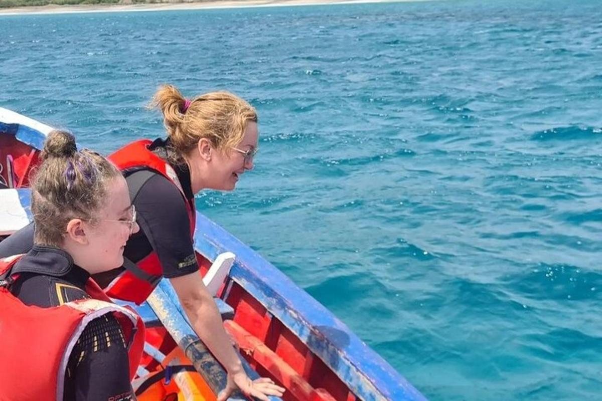 a woman and a child in a boat in the water