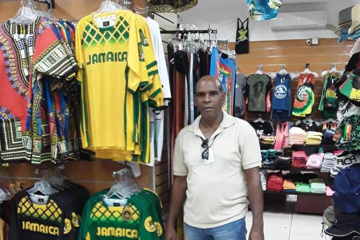 a man standing in front of a store with shirts