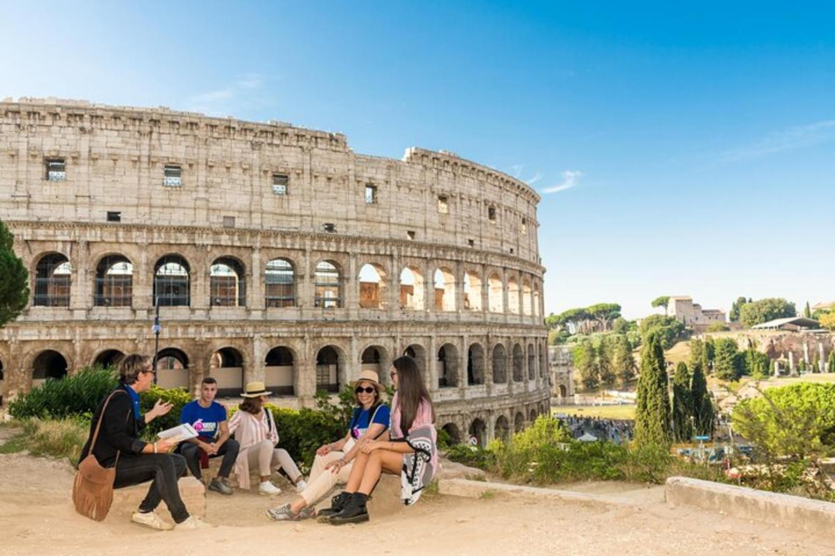 a group of people sitting in front of the coliseum