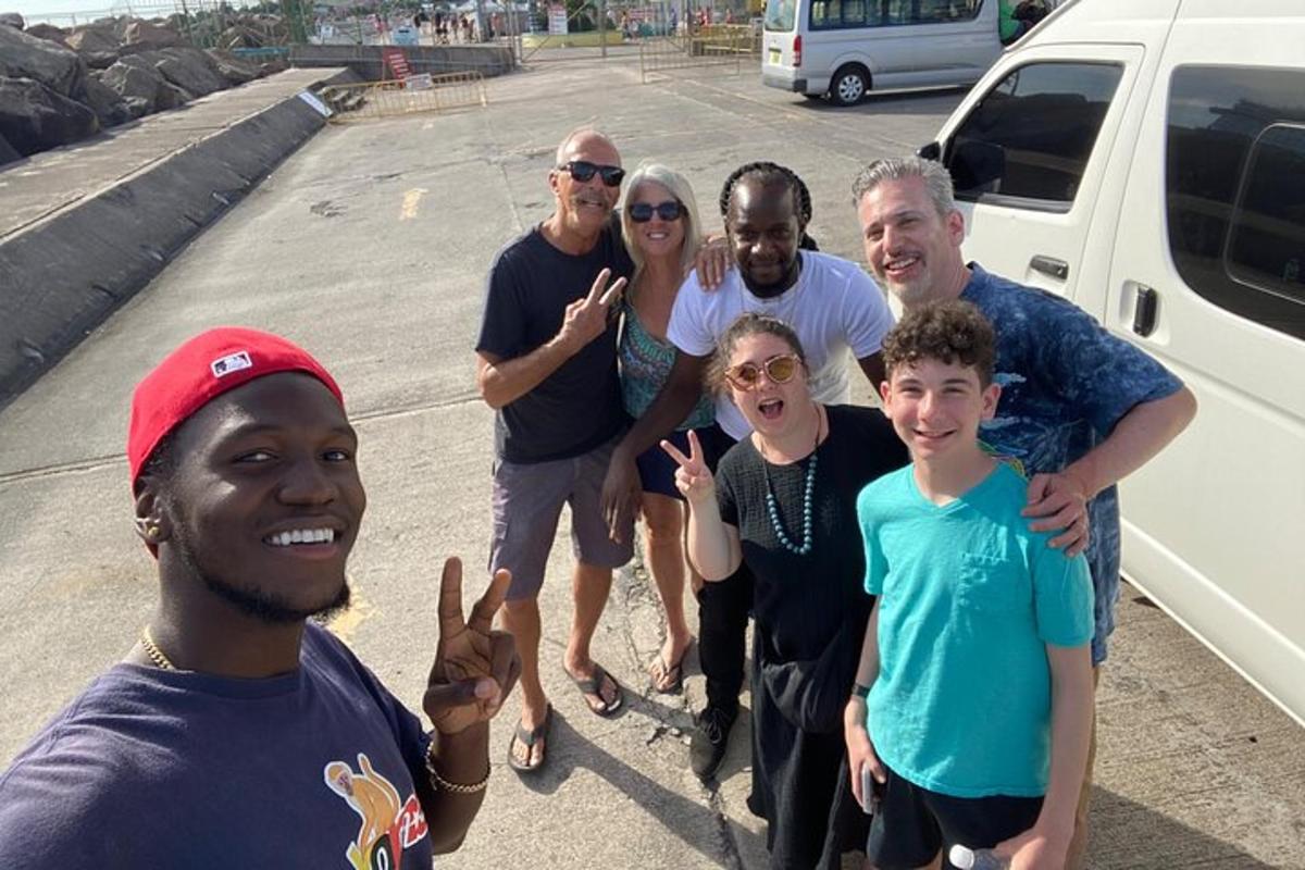 a group of people posing for a picture in a parking lot