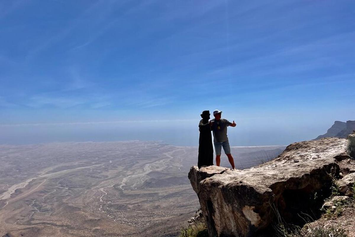 two people standing on top of a mountain