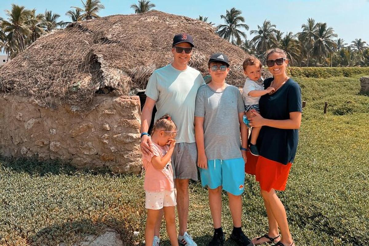a family is posing for a picture in front of a mound