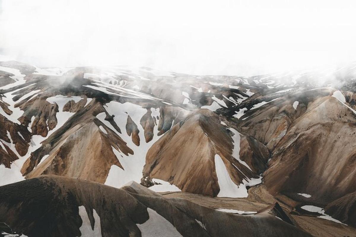 an aerial view of a snowy mountain range