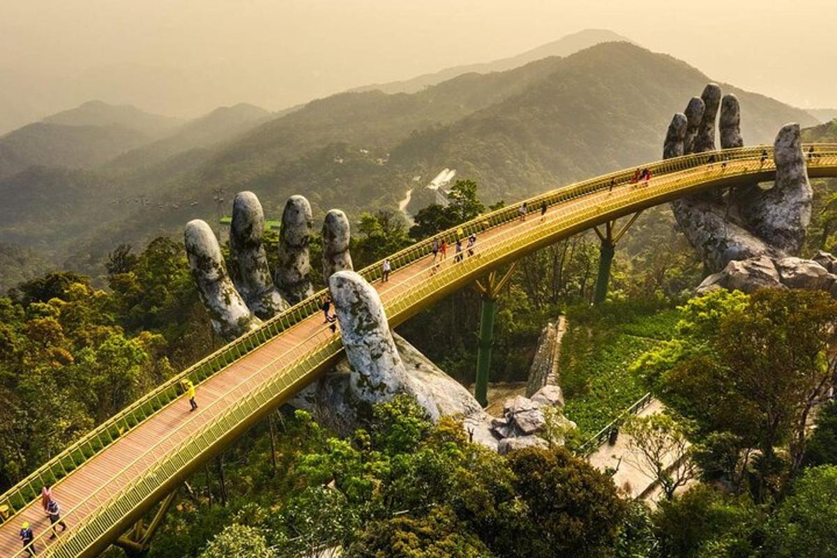 Un grupo de personas caminando sobre un puente frente a un gigante que se extiende