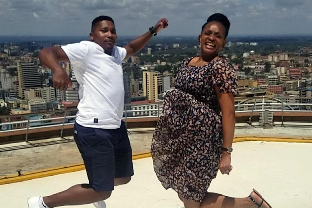 a man and a woman dancing on top of a building