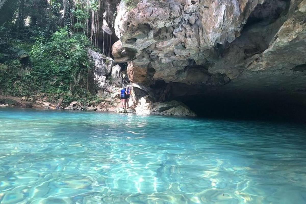 a person standing in the water in a cave