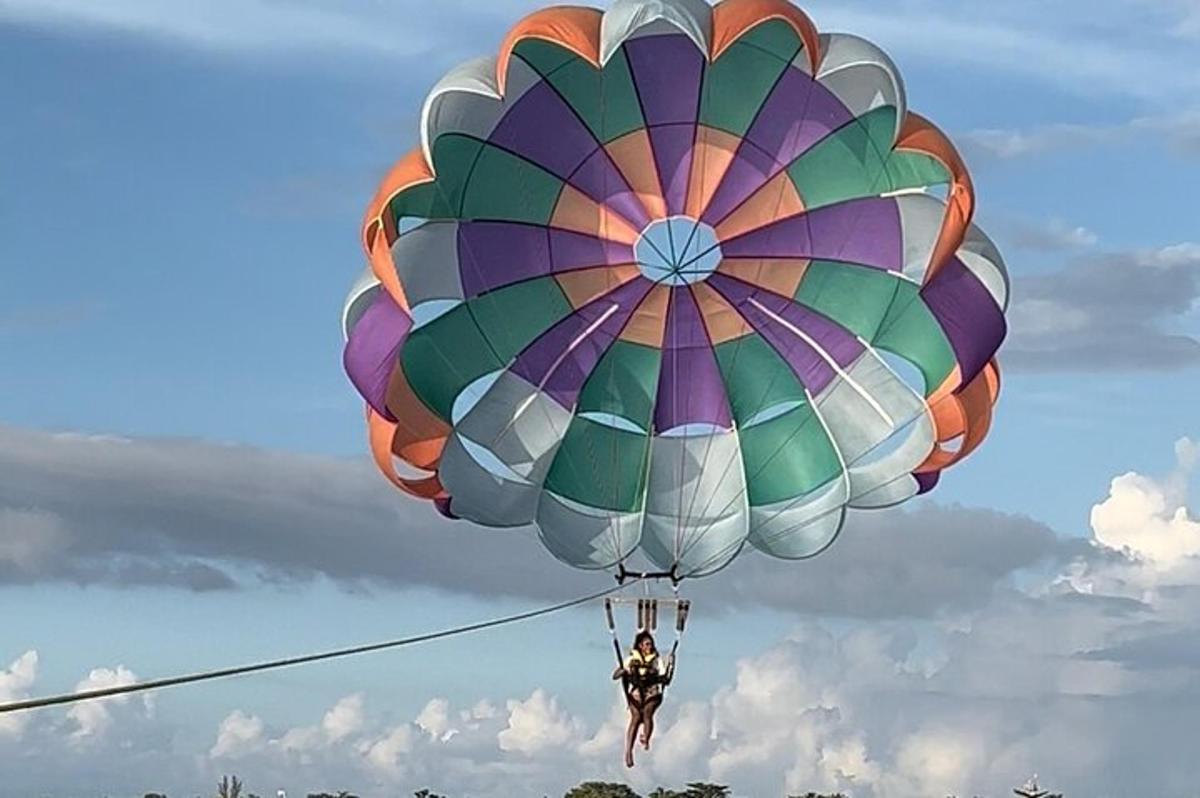 空に浮かぶ大きなパラシュートに乗った人