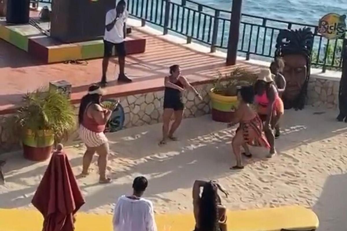 un grup de oameni care se joacă în nisipul de pe plajă