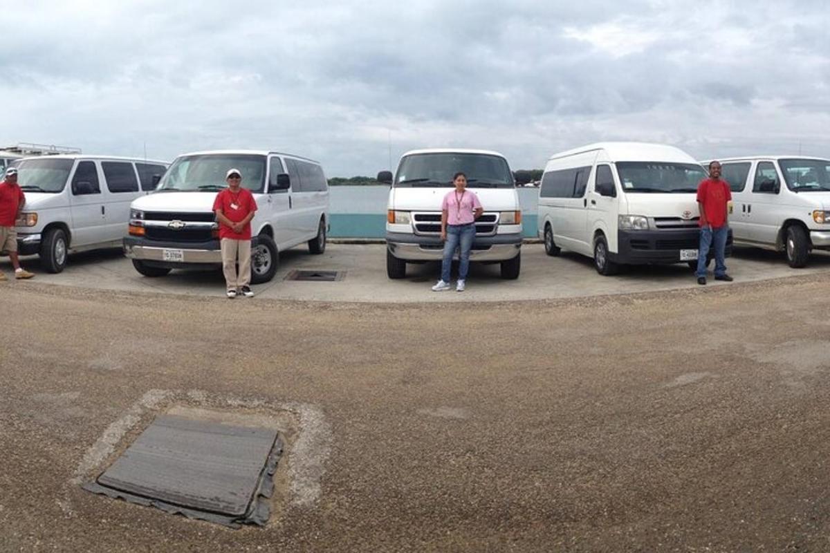 a group of people standing in front of white vans