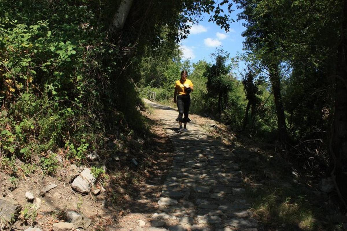 a woman walking down a dirt road