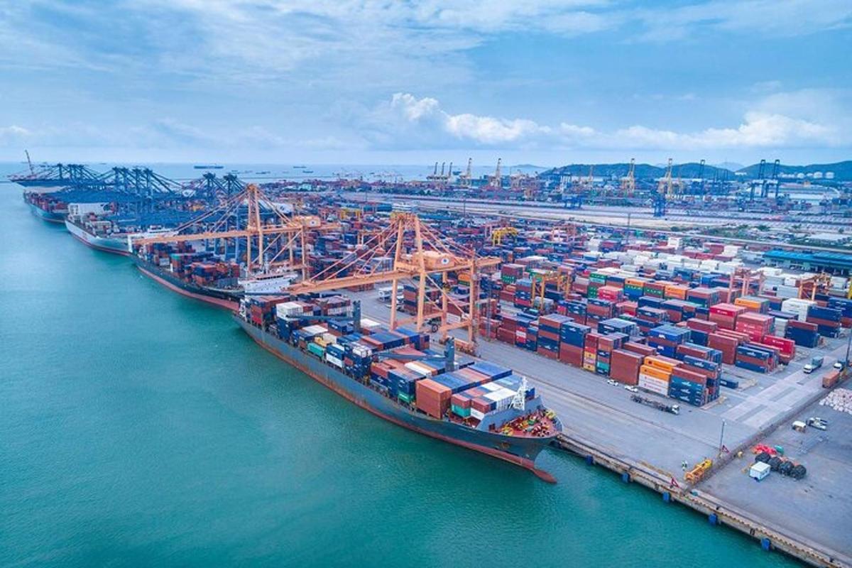 an aerial view of a harbor with a large cargo ship
