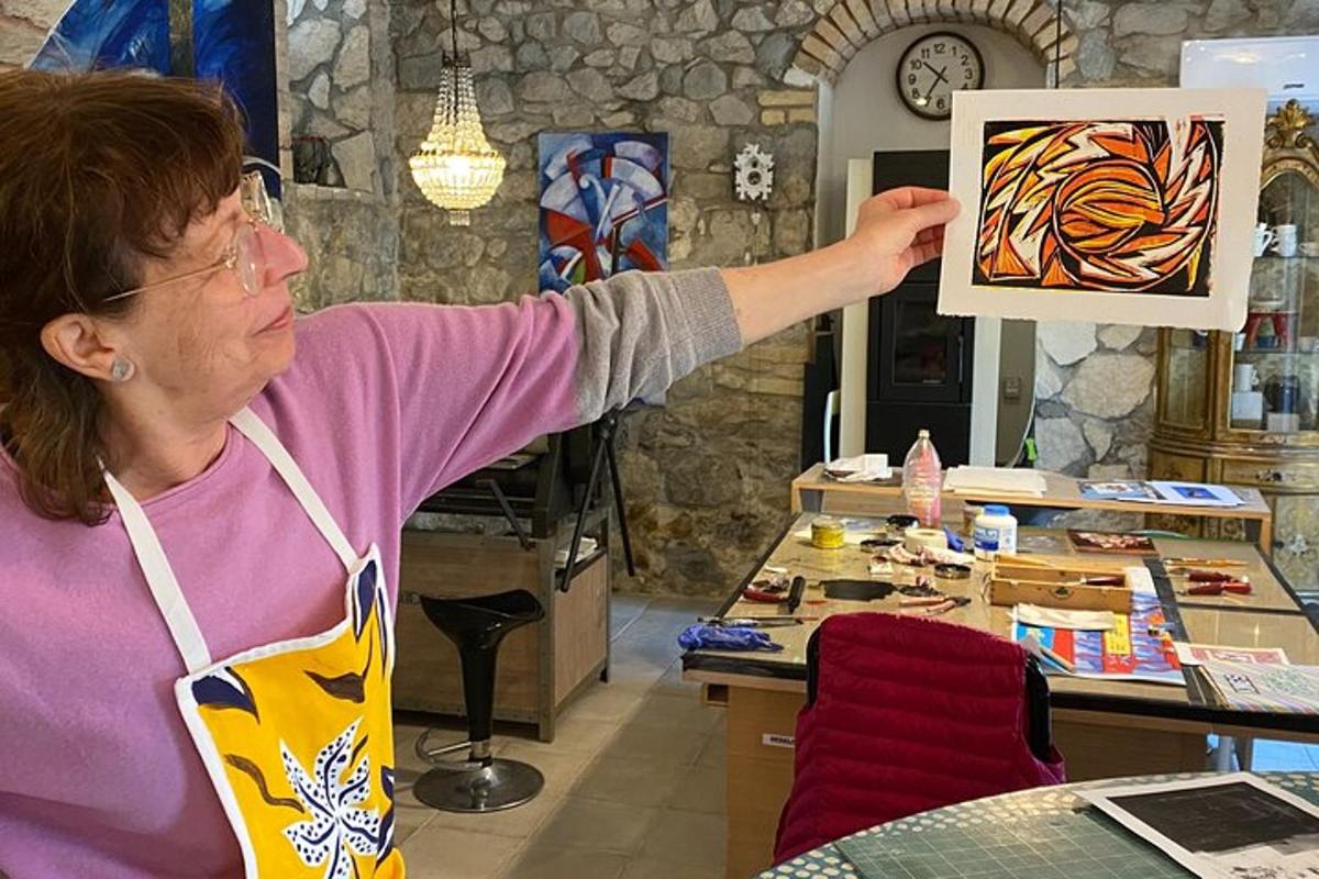 a woman is holding up a painting in a store