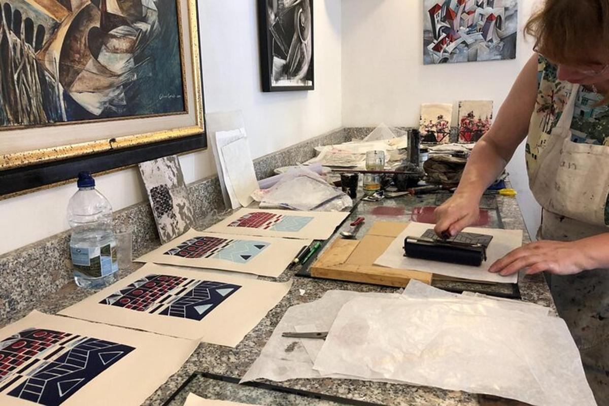 a woman standing at a table with art supplies