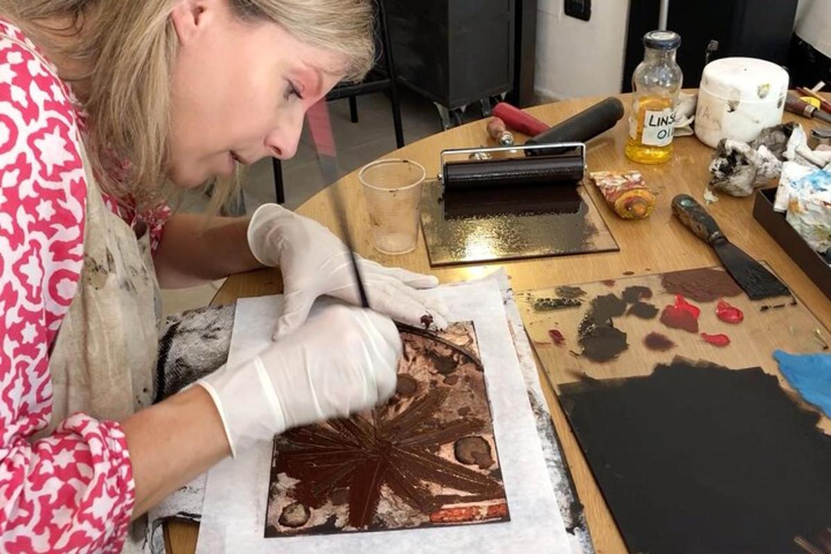 a woman is painting a picture on a table