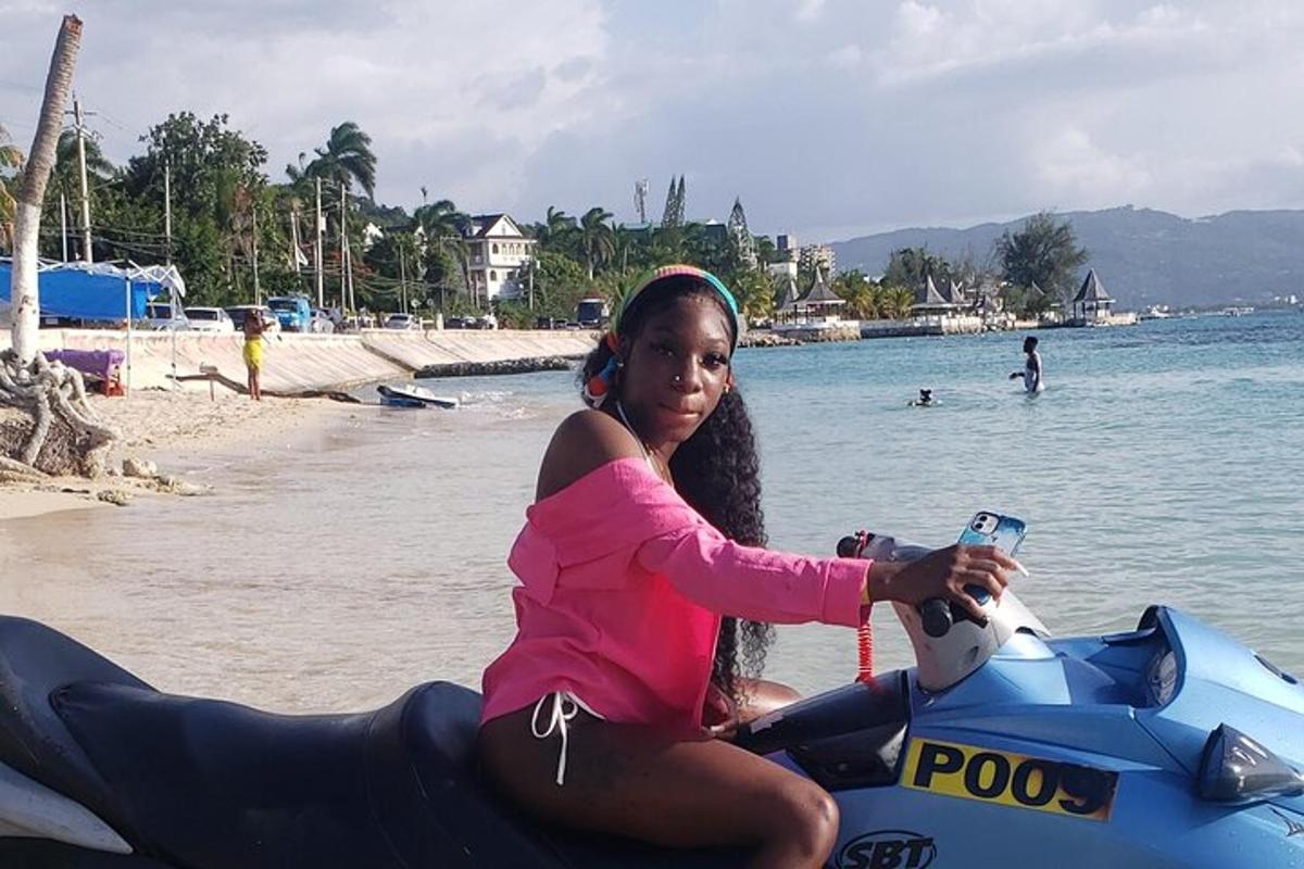 eine Frau sitzt auf einem Jetski am Strand