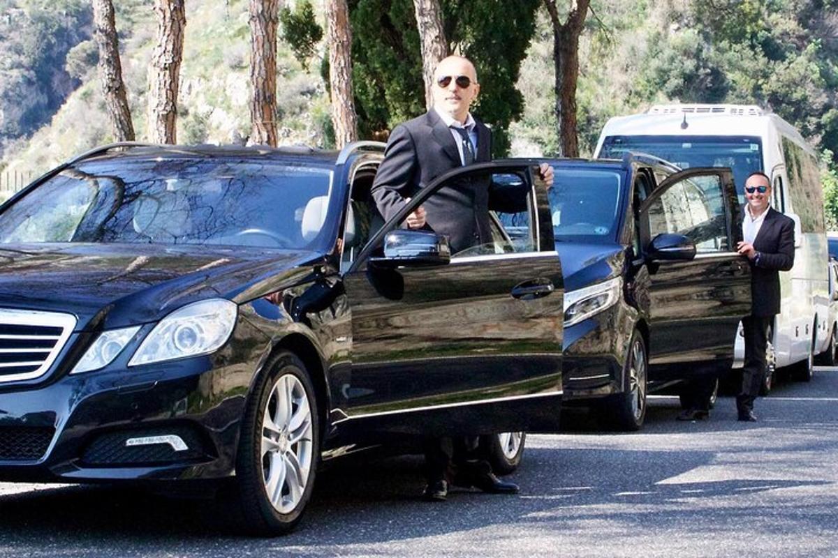 a man getting out of a black car