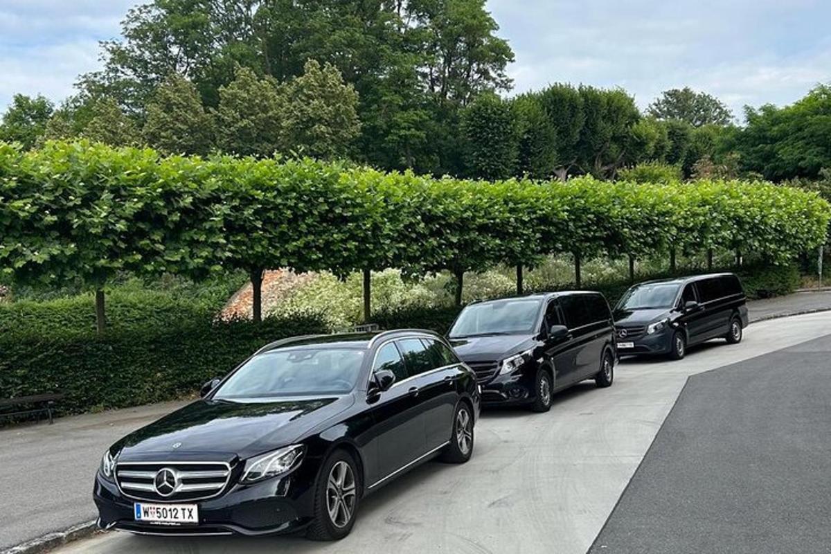 three luxury cars parked in a parking lot