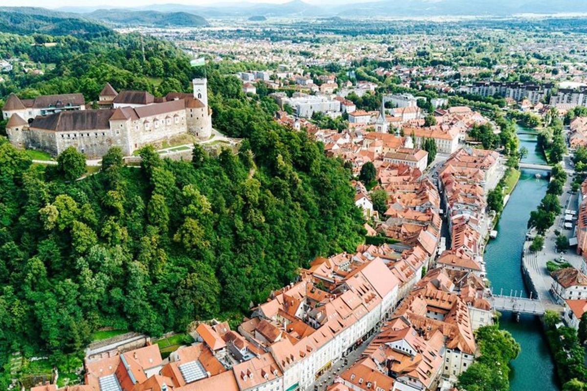 an aerial view of a city with a river and buildings