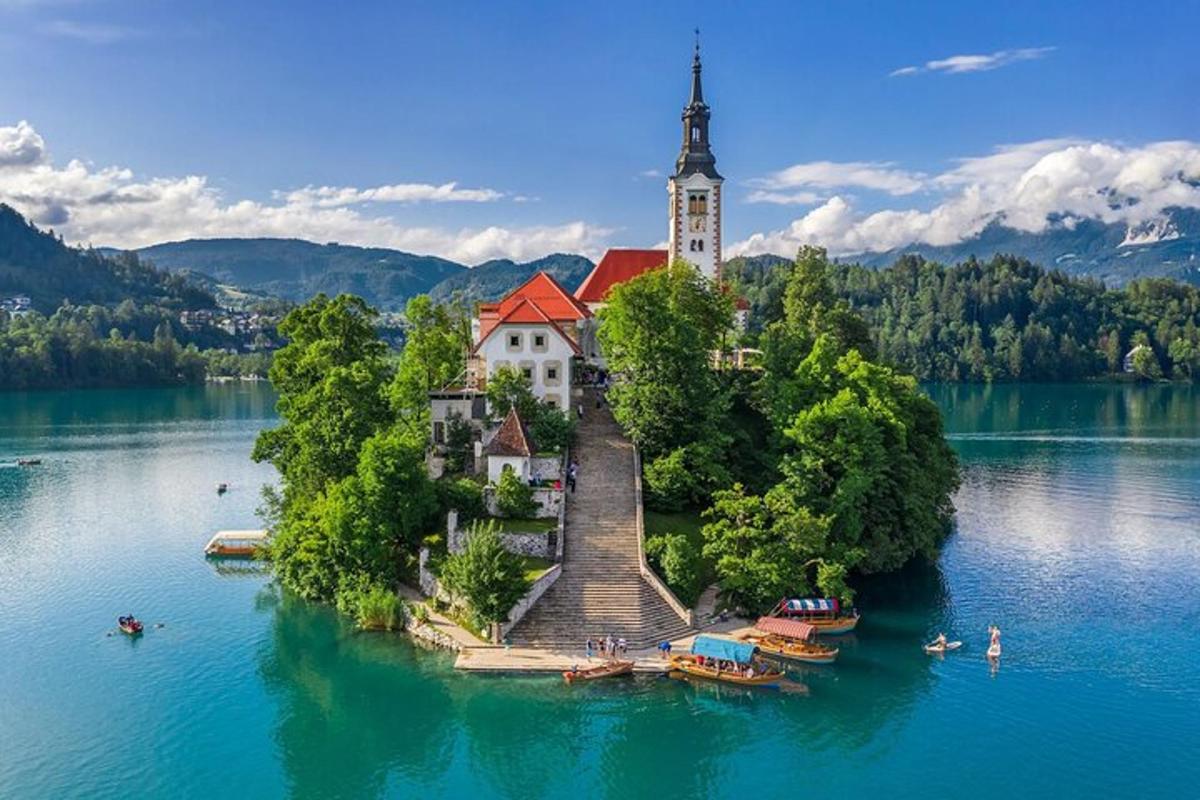 an island in the middle of a lake with a church