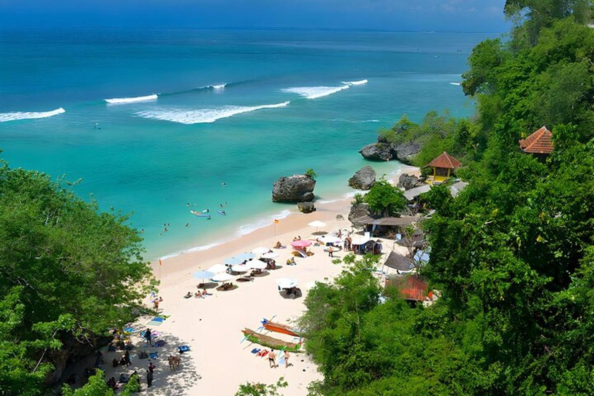 pantai dengan payung dan orang di dalam air