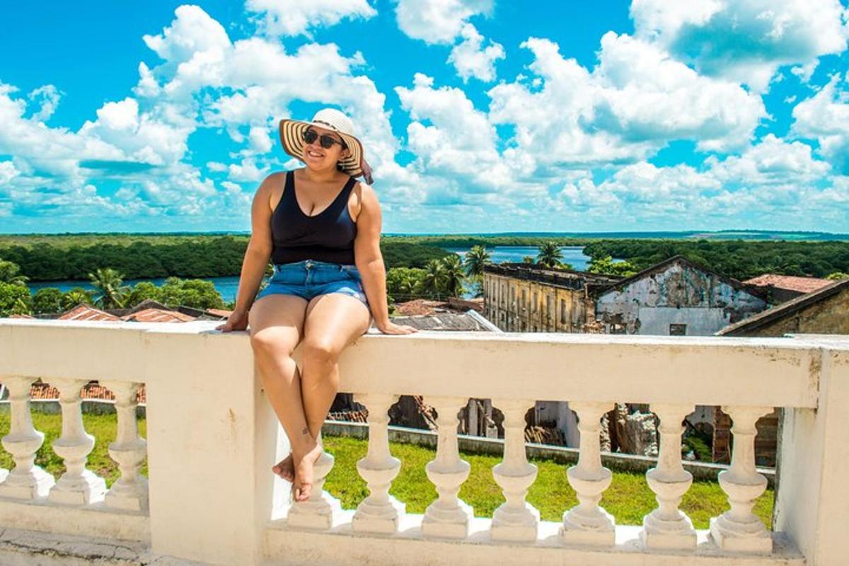 a woman sitting on the ledge of a balcony