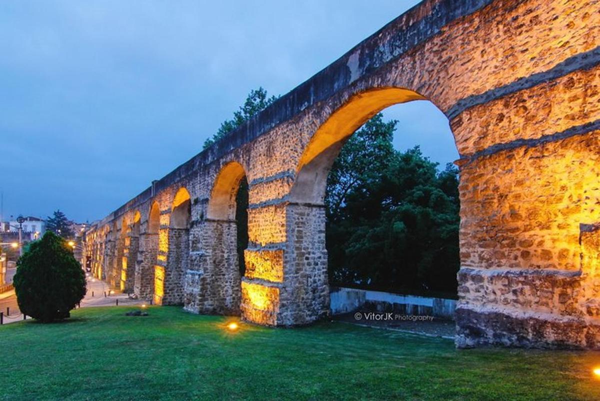 un pod vechi de piatră cu o arcadă noaptea
