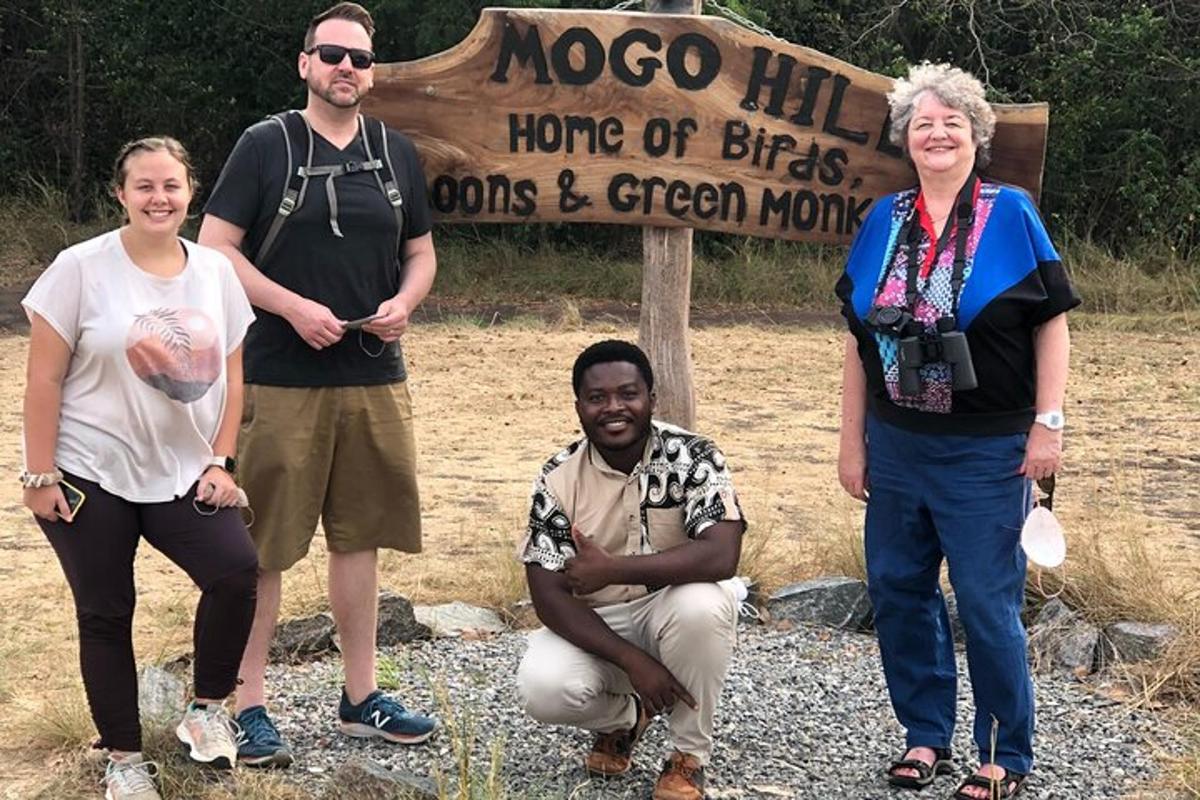 a group of people standing in front of a sign