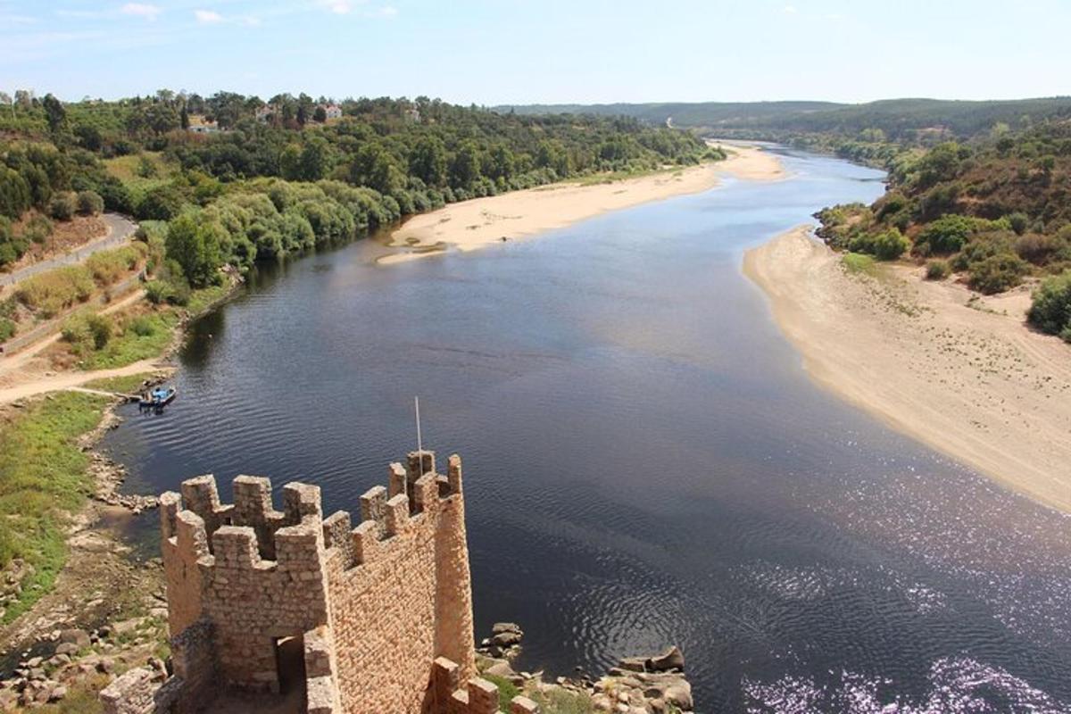 an aerial view of a castle next to a beach