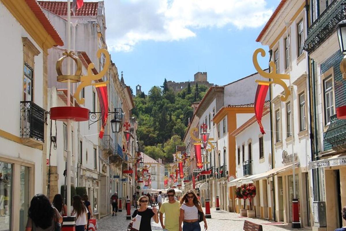 a group of people walking down a street with buildings