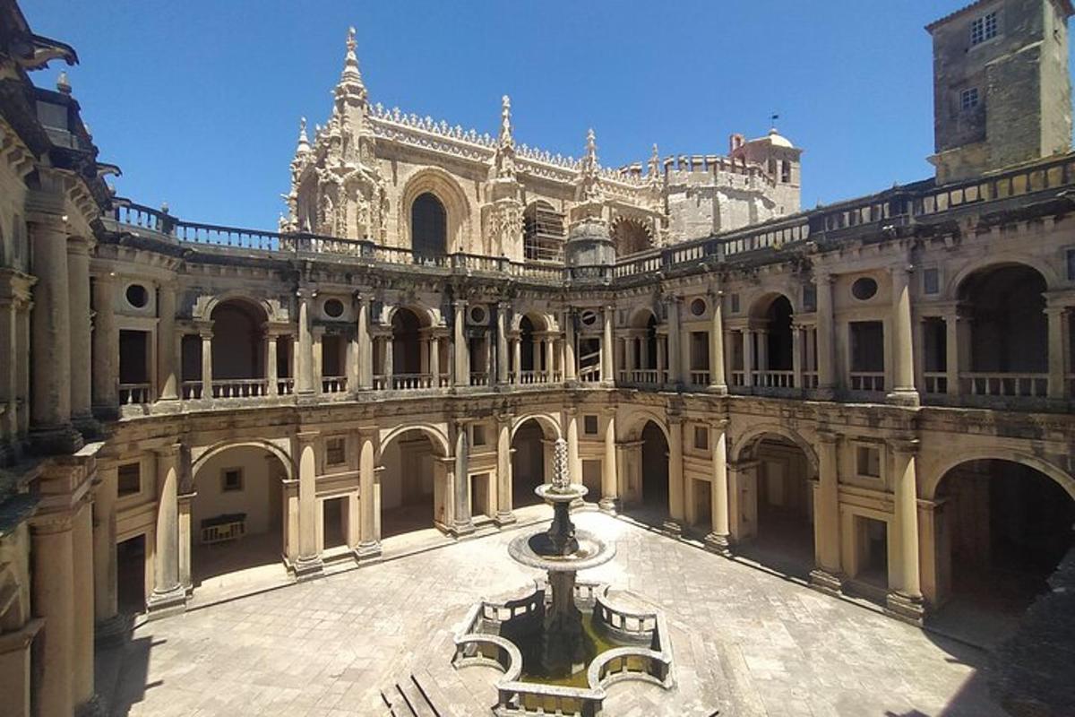 a large building with a fountain in a courtyard