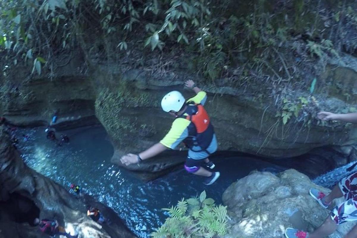 a man standing on a rock in a river