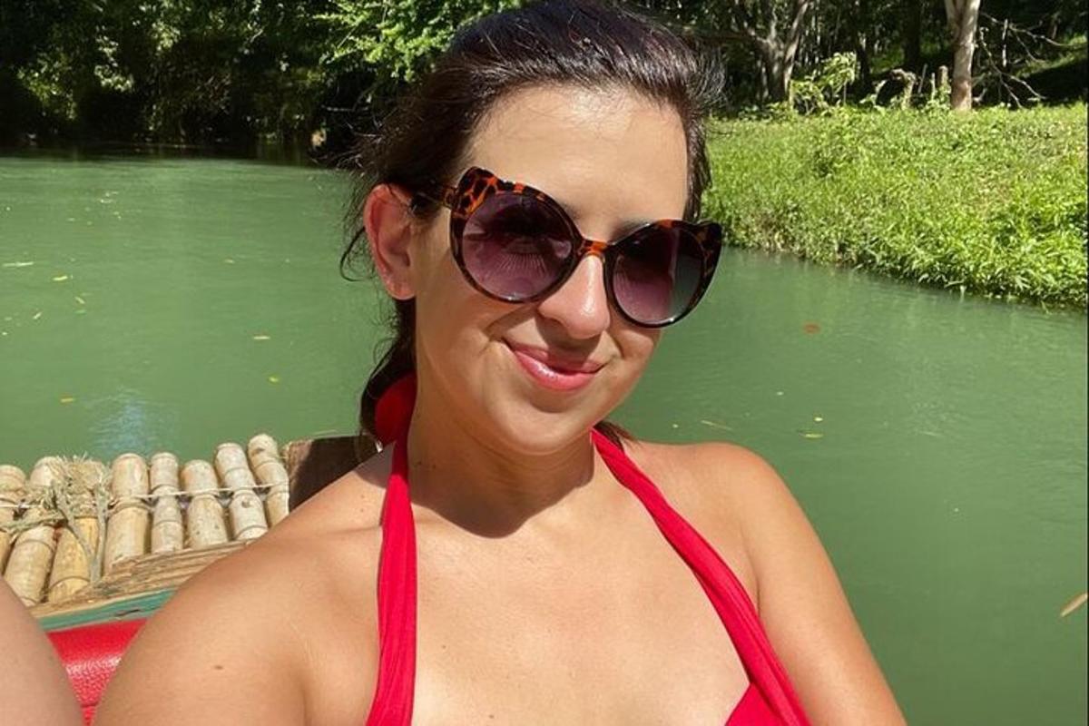 o femeie purtând un bikini roșu și ochelari de soare pe o barcă